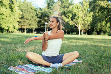 woman does physical exercises outdoor in park