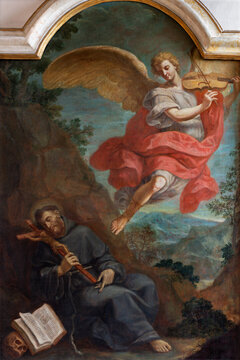 FERRARA, ITALY - NOVEMBER 9, 2021: The painting of Vision St. Francis of Assisi with the angel playing violin in church Chiesa di San Francesco by G. Mazonni (1673 - 1767).