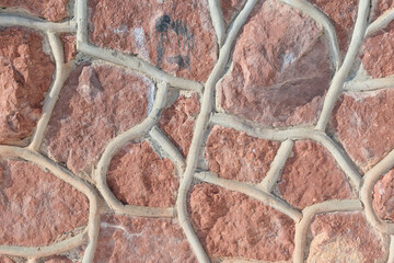 Redstone wall. Cement joints. Textured background concept.