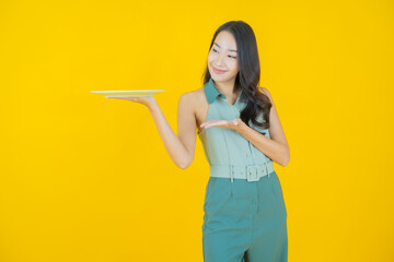 Portrait beautiful young asian woman smile with empty plate dish
