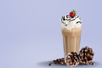 Caramel coffee milk and caramel drink in glass on wooden table with coffee beans.