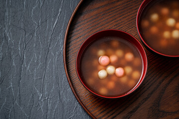Red and white tangyuan with syrup soup.