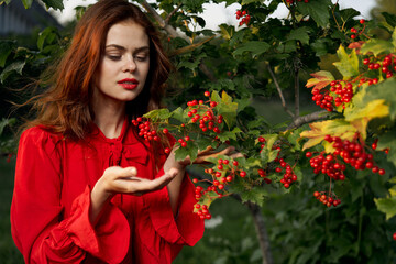 pretty woman in the summer outdoors near the bush