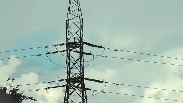 Electric High Line High Voltage Electric Tower With Cloudy Sky in the Background Transmission Power Line. High Voltage 4K