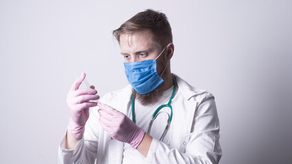 Male doctor in laboratory coat on gray background