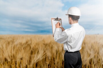 Architect using digital tablet surveying a new residential housing building land plot