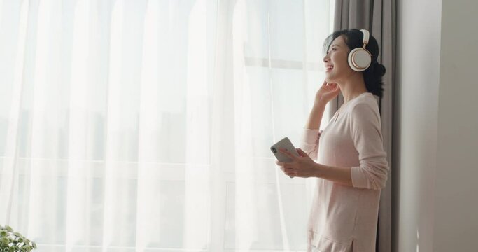 Happy young woman listening to music,4K