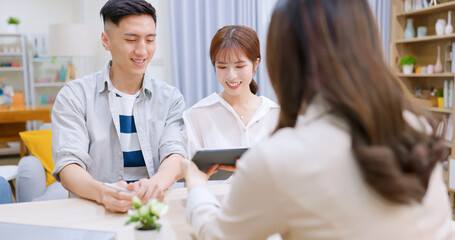 asian couple signing a contract