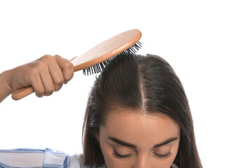 Woman with hair loss problem on white background, closeup. Trichology treatment