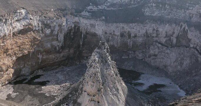 An active volcano from the mouth of which comes smoke. Beautiful and dangerous nature on top of the mountain.