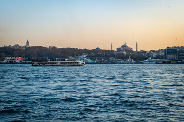 Fototapeta premium Bosphorus, the Strait of Istanbul, cruise and ferry view at sunset. Istanbul cityscape with the famous landmarks seen from Bosphorus. 