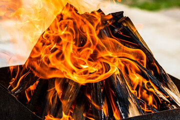 Empty hot charcoal barbecue grill with bright flame. Hot burning grill, outdoors cooking food