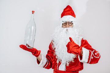 Santa Claus holding a bottle. Glass transparent bottle