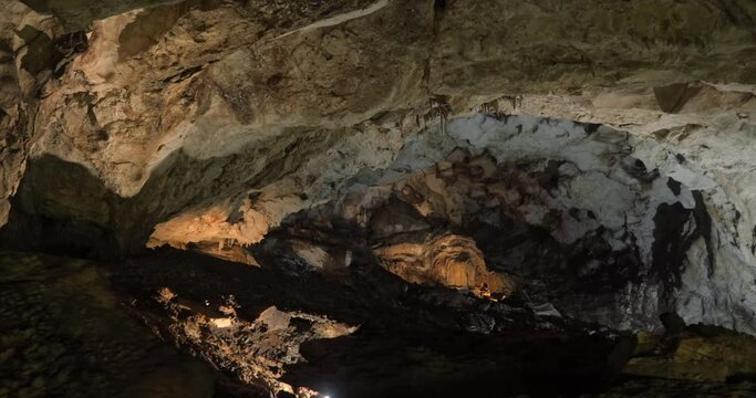 Beautiful landscape of Lipa Cave in Serbia. Stalagnets and stalactites hanging over the ground, stones in the middle of the mountain.