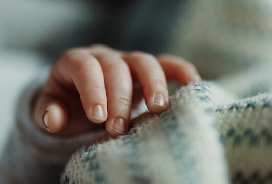 A Close-up Shot Of A Three Week Old, Newborn Baby Boy's Hand.
