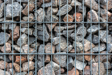 Details of a gabion stone basket with wire mesh and stones