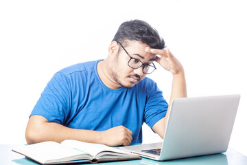 young man feeling exhausted by working on laptop, man got headache watching at computer screen