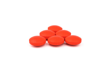 Red pills on a white background, isolated. Pharmacy. Treatment.