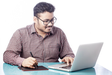 photoshop editor or retoucher drawing on illustrator with digital graphic tablet and stylus pen on laptop