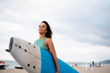 Obraz premium Beautiful hot woman with surfboard. Fit girl preparing for the surf. Beautiful woman enjoy in sunny day