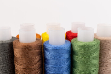 Color sewing threads isolated on white background. Different colors.Bright bobbin thread.