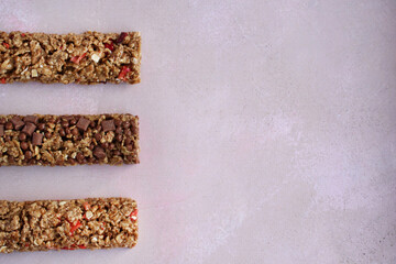 cereal fitness bars with berries on a purple background with a copy space