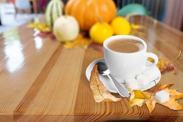 Autumn composition with pumpkins, leaves and pumpkin latte coffee on the desk