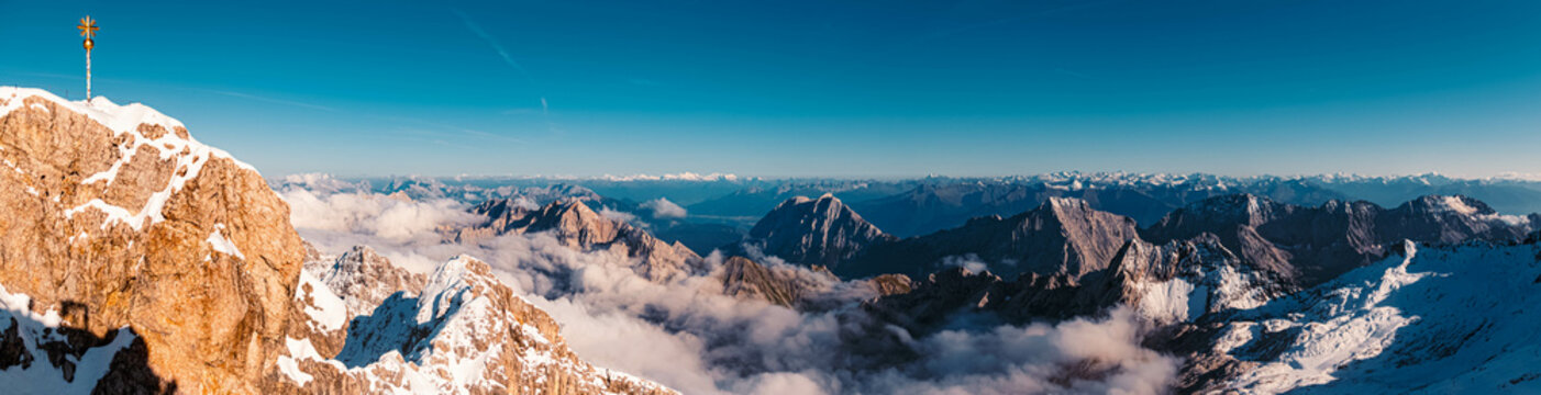 High resolution summer panorama with the summit cross of the famous Zugspitze summit, top of Germany, near Ehrwald, Tyrol, Austria and Garmisch-Partenkirchen, Bavaria, Germany