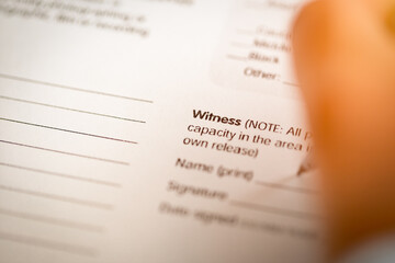 The word Witness on the paper contract.