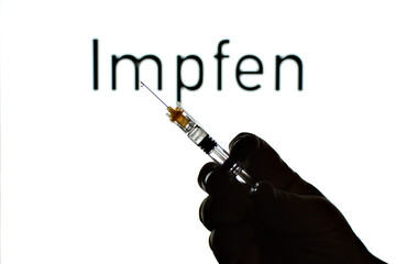 Hand holds syringe for vaccination