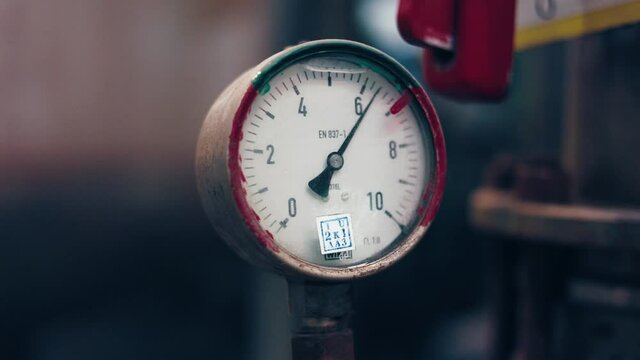 Dark surface with a deep reflection of pressure gauges.manometer in focus. A pressure gauge on the background of other instruments.