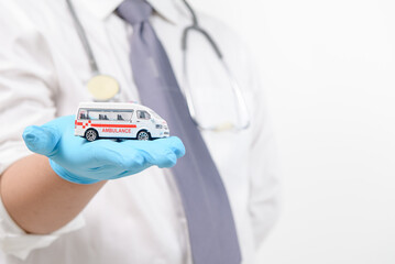Ambulance model in doctor hand isolated on white background,