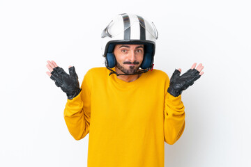 Young caucasian man with a motorcycle helmet isolated on white background having doubts while raising hands