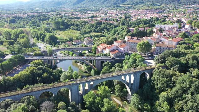 General view from drone of Ceret town on banks of river Tech in foothills of Pyrenees mountains in summer, France