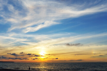 Obraz premium Sunset over the sea. Reflection of sunlight in the sea waves. The sky in the sunset rays.
