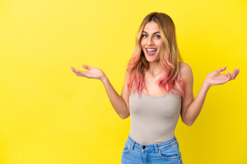 Young woman over isolated yellow background with shocked facial expression