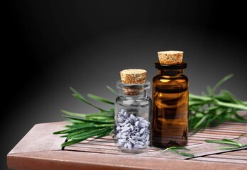 Oud Oils bottle with agarwood on dark background