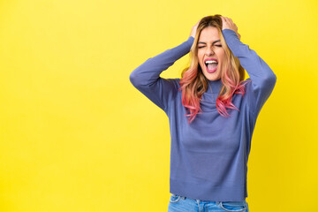 Young woman over isolated yellow background stressed overwhelmed