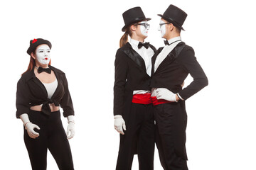 Portrait of three mime artists performing, isolated on white background. Two men embrace, and the girl is perplexed. Symbol of tolerance, same-sex marriage, the LGBT community