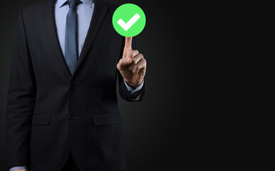 Hand holds green icon Check mark,Check Mark Sign, Tick Icon,right sign,circle green checkmark button,Done.On dark background.Banner.Copy space.Place for text.