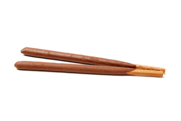 Breadsticks covered with chocolate on white background