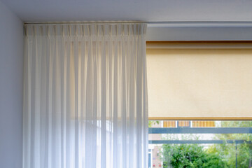Light and see through concept, Classic white sheer curtains hanging by the window in the room with...