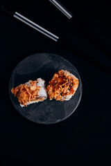 sushi on a plate black background