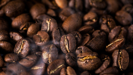 Coffee beans texture or coffee background. Fragrant fried bean  a-smoke.
