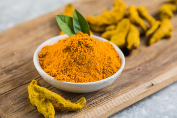 Indian turmeric powder and root. Turmeric spice.
