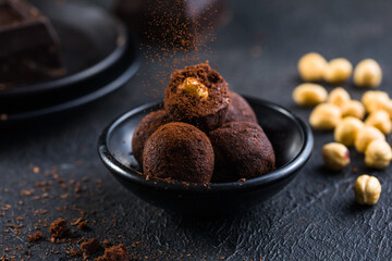 Homemade fresh truffle dark chocolate candies with cocoa powder made by chocolatier. Gourmet food, delicious dessert.