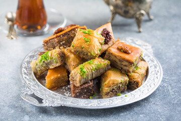 Traditional Turkish Desserts Baklava with  Tea. Crispy mix baklava on silver  plate.