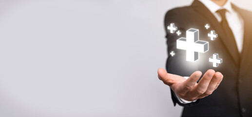 Businessman, man hold in hand offer positive thing such as profit, benefits, development, CSR represented by plus sign.The hand shows the plus sign