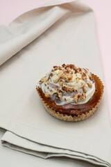 Cake with nuts on a beige towel in the kitchen