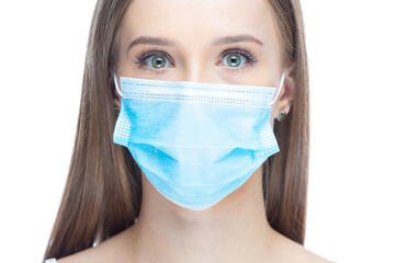 Closeup portrait of a young woman wearing a face mask under stress from coronavirus disease, looking at camera, isolated on white background. Flu epidemic, dust allergy, protection against virus